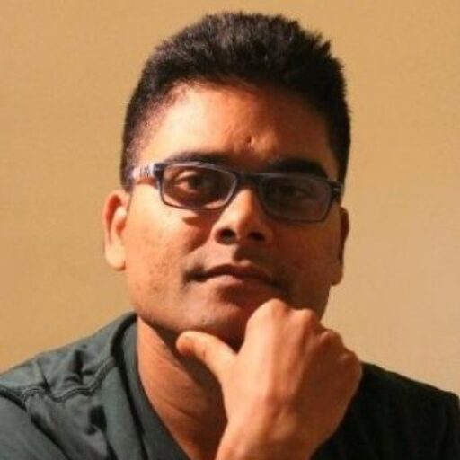 "Photo of Rehan Usmani wearing glasses, resting his hand on his chin, looking thoughtful."